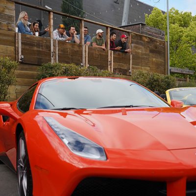 Event outdoors photo of people and a red car