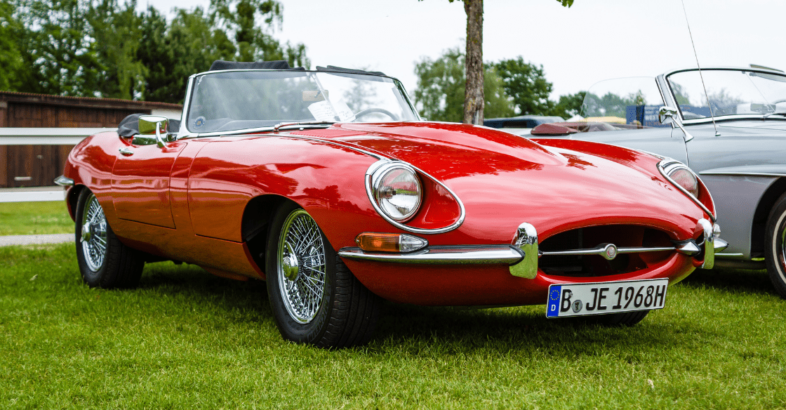Jaguar E-Type on a grass field.