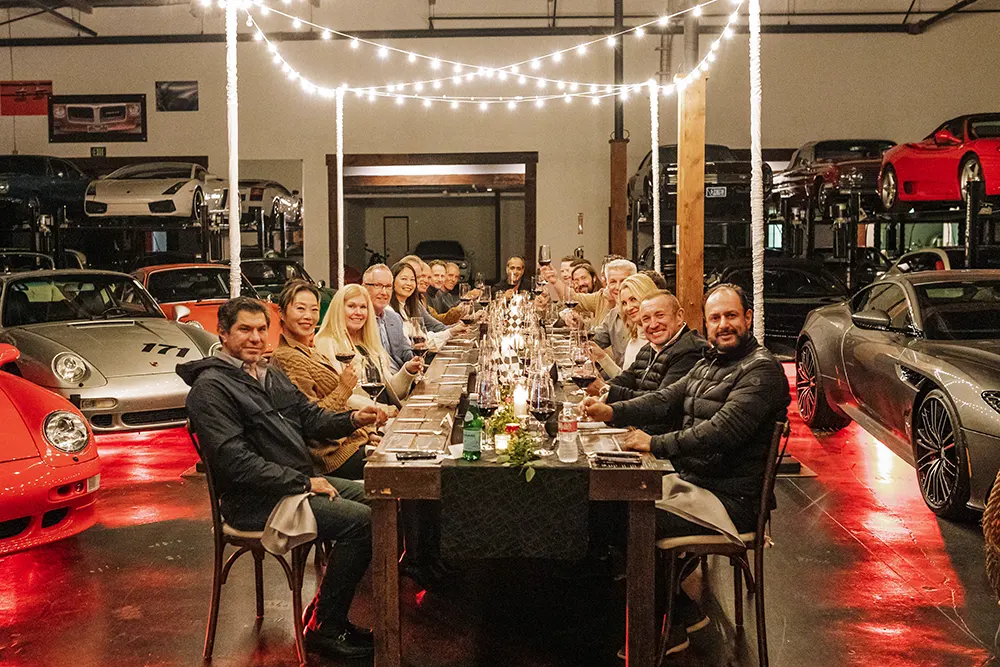 Members sitting at a large dining table at the Vault